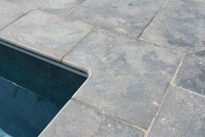 Pool surrounds and 90° internal corner coping in Farley Black Limestone.