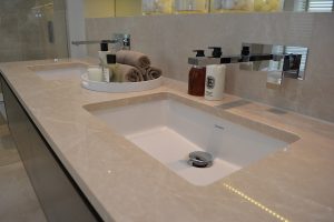 Bespoke bathroom sink vanity tops in Crema Almera Polished Limestone.