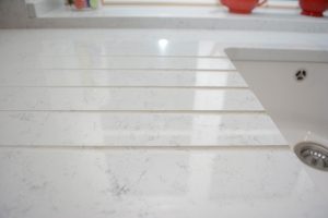 Drainage flutes cut into Lapitec® surface on kitchen worktop.