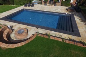 Boston Porcelain pool coping and steps, with Cotswold Mint Riven Sandstone surrounds.