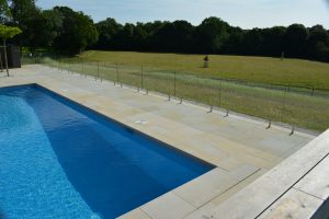 Danebury Sandstone pool paving with a pit lid 