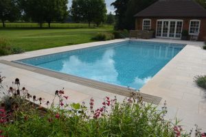 Fossil Pearl Tumbled Outdoor Swimming Pool Coping and Paving.